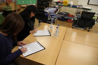 Dos trabajadoras rellenando el cuestionario previo a la extracción