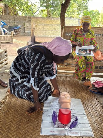 Ayudante de matrona con el muñeco de rcp
