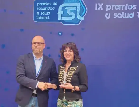 Fotografía de entrega de premio. Gráfico de hombre y mujer interactuando.